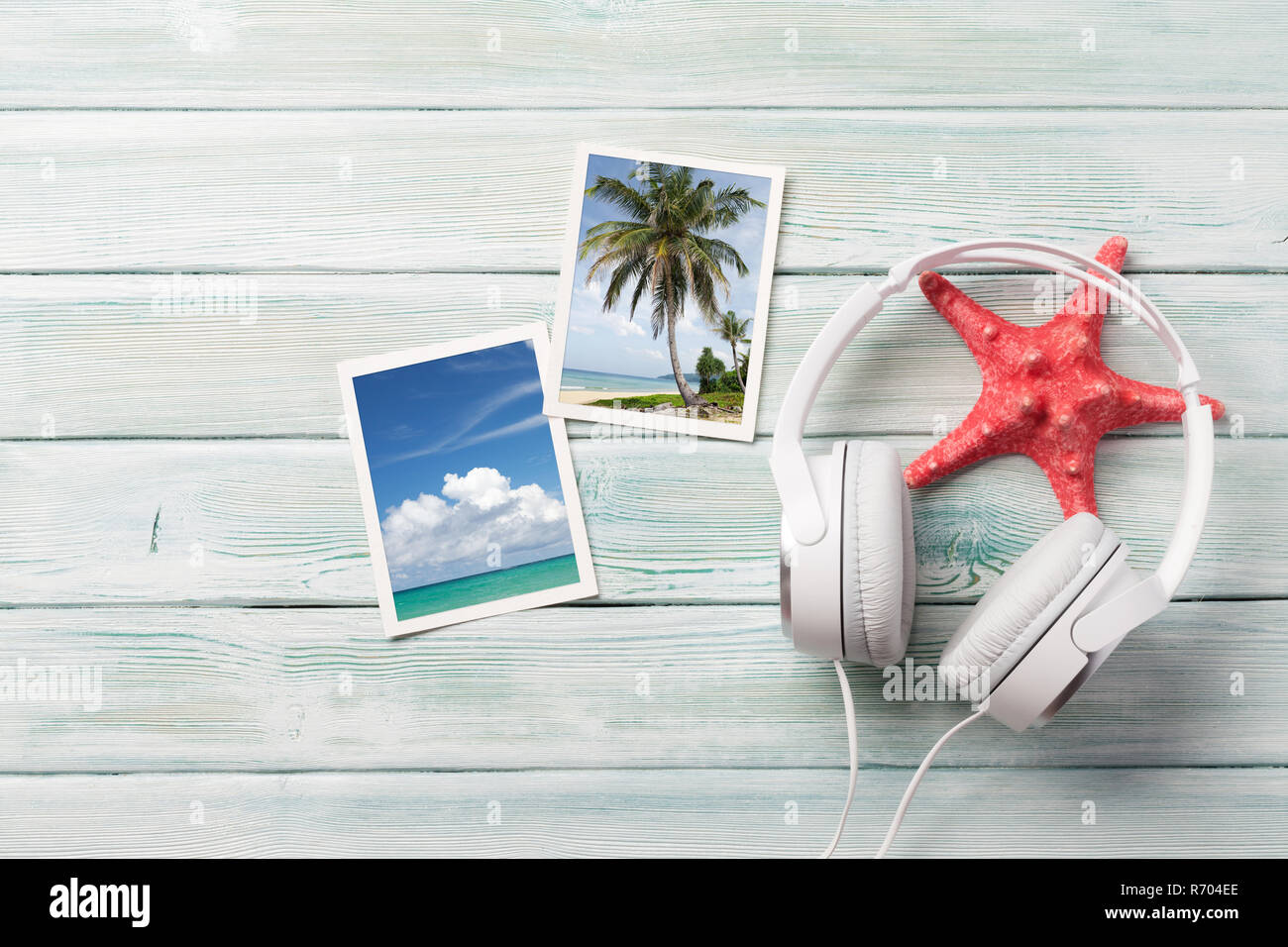 Travel vacation and music concept with headphones, starfish and photos on wooden backdrop. Top view with copy space. Flat lay. All photos taken by me Stock Photo