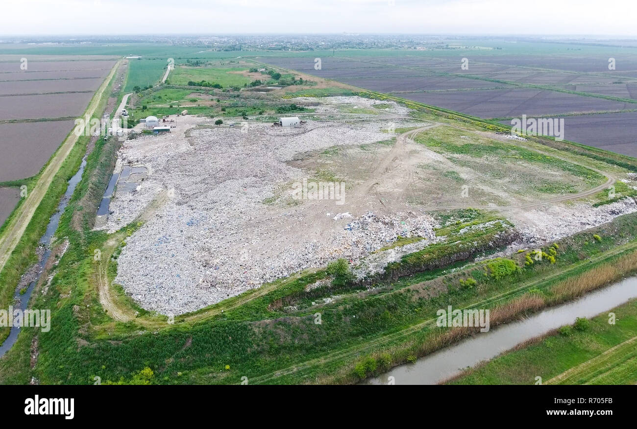 garbage dump with heaps of garbage and treatment facilities. Landfill