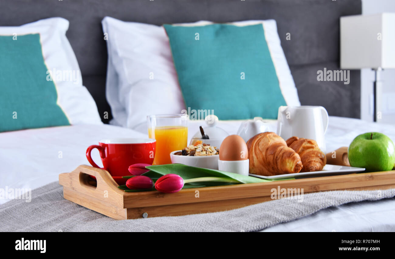 Breakfast on tray in bed in hotel room Stock Photo - Alamy