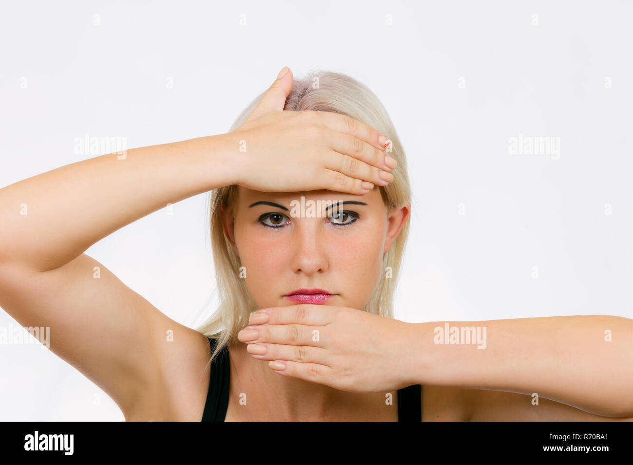 Face exercise palm resist, woman holds her head with her palms on ...