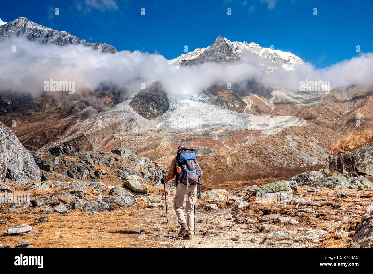 Nepal, hiker at Langtang Valley with Langtang Lirung mountain massif in ...