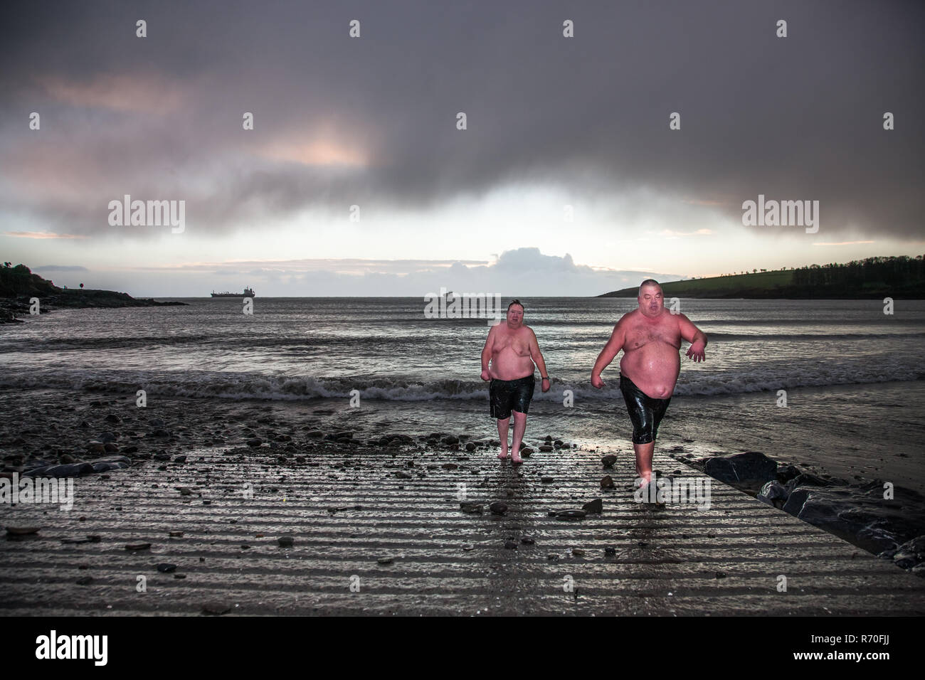 Fountainstown, Cork, Ireland. 07th December, 2018. Friends Seamus Murphy, Carrignavar and Brian O' Connor, Crosshaven emerge after their daily morning swim at Fountainstown Beach, Co. Cork, Ireland. Credit: David Creedon/Alamy Live News Stock Photo