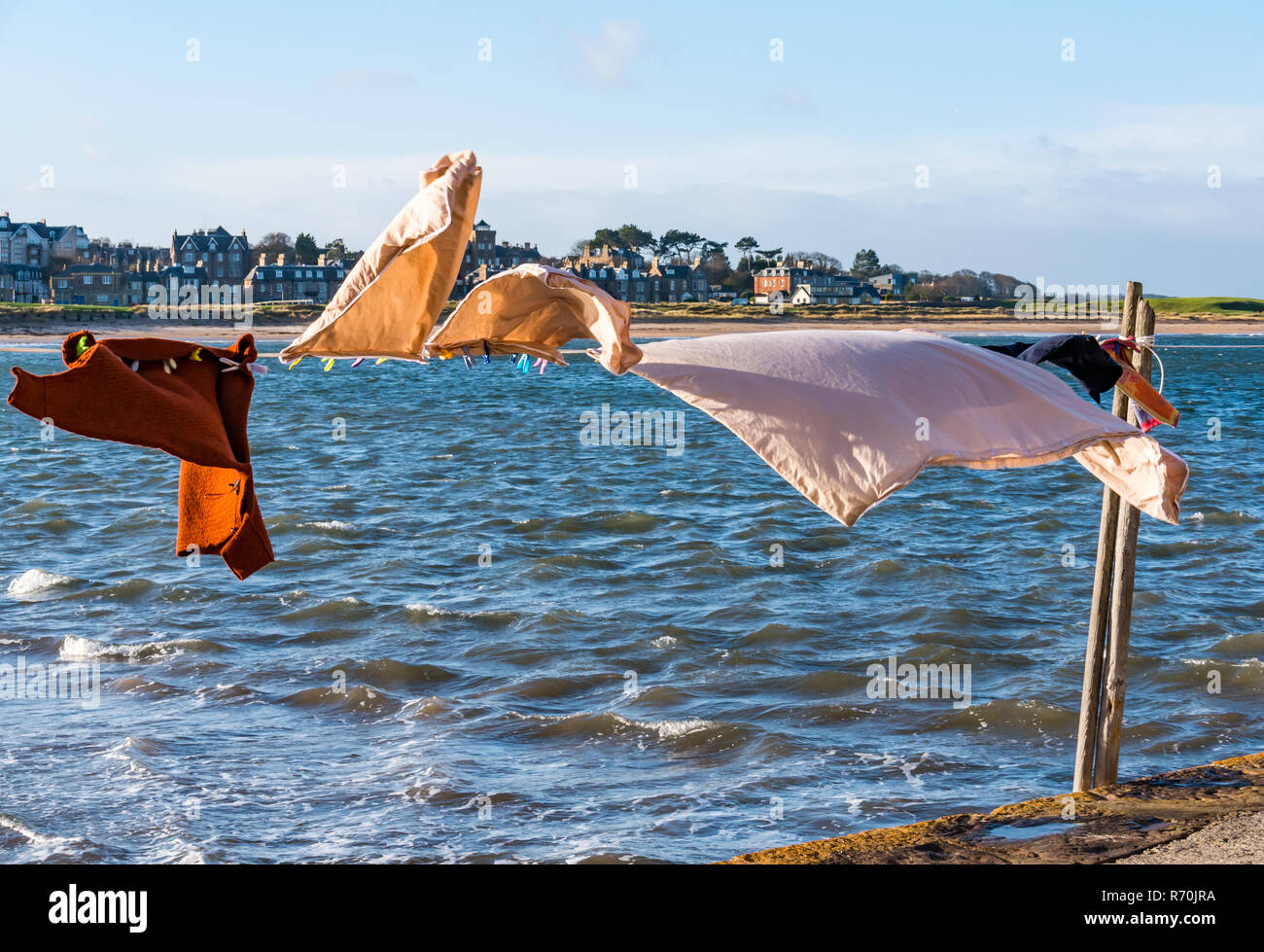 North Berwick, East Lothian, Scotland, United Kingdom. 7th December 2018. UK Weather: A bright sunny but very windy day in the seaside town with washing hanging on a line blowing in the wind on the firth of Forth seafront Stock Photo