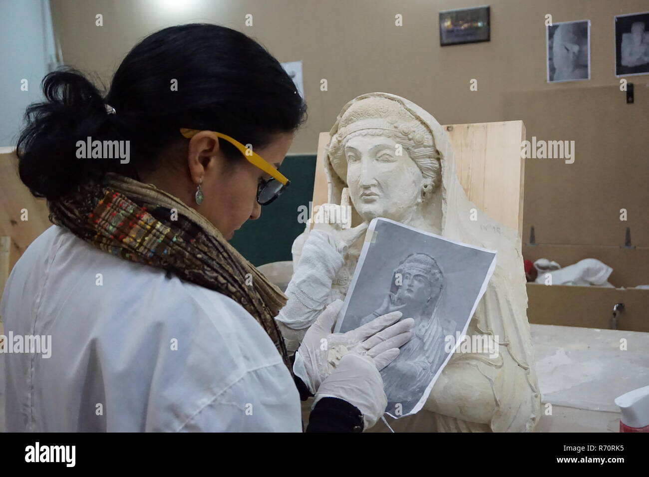 (181207) -- DAMASCUS, Dec. 7, 2018 (Xinhua) -- Heba Jouma, a conservator-restorer from the ancient city of Palmyra in Syria and a member of a Syrian restoration experts' team, works at the National Museum of Damascus in Damascus, Syria, on Dec. 5, 2018. Heba Jouma works to bring back ancient features to the sculptures damaged by the Islamic State (IS) group. The IS group had stormed Palmyra twice during the more than seven-year-long war, destroying precious archeological sites, such as temples and tombs, and shattering sculptures into pieces in the ancient oasis city, which is registered by th Stock Photo
