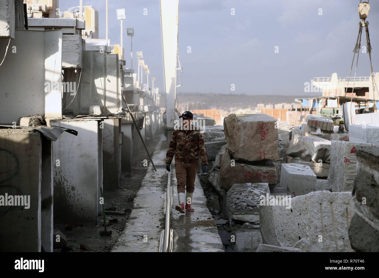 Cairo, Egypt. 6th Dec, 2018. A man walks in a marble and granite factory in Cairo, Egypt, on Dec. 6, 2018. In Shaq al-Thu'ban vast marble and granite industrial cluster near Egyptian capital Cairo's Maadi district, about 40 Chinese and Egyptian cooperative granite factories and 30 marble factories have significantly contributed to boosting the industry in the most populous Arab country. Credit: Ahmed Gomaa/Xinhua/Alamy Live News Stock Photo