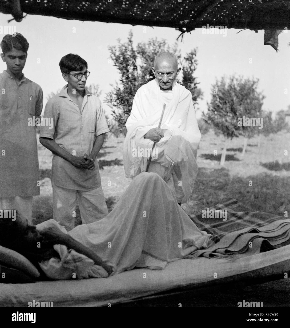 Mahatma Gandhi talking to a patient at Sevagram Ashram, Wardha, Maharashtra, India, 1941, old vintage 1900s picture Stock Photo