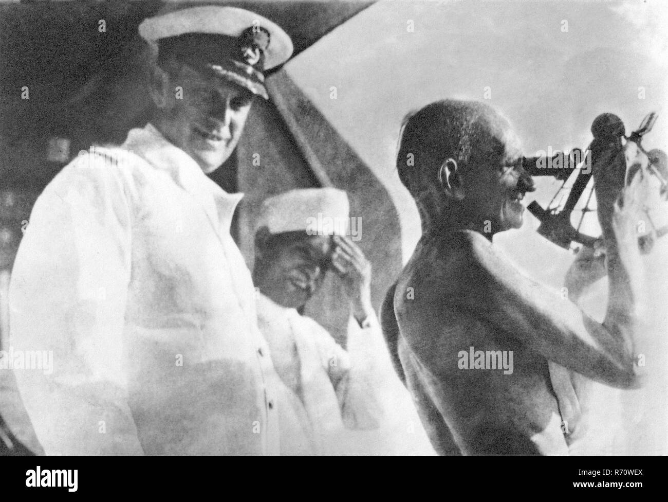 Mahatma Gandhi handling a nautic instrument on the captain bridge of SS Rajputana, British passenger ship, September 1931, old vintage 1900s picture Stock Photo