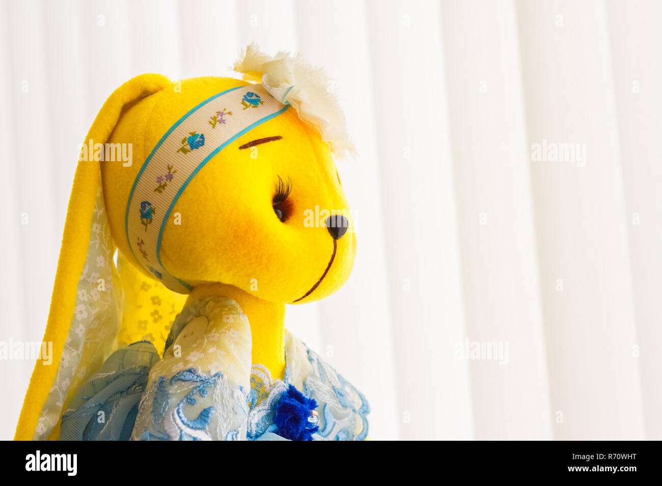 Handmade yellow doll bunny close-up in blue dress Stock Photo - Alamy