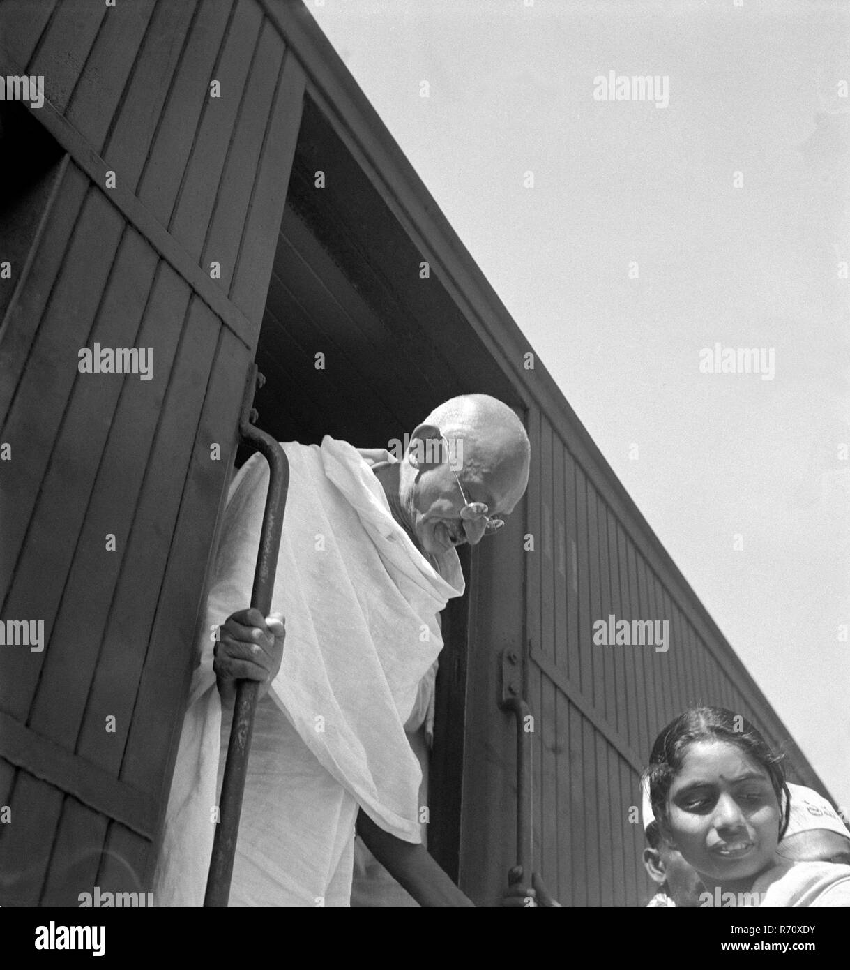 Mahatma Gandhi alighting from a third class train compartment at Madras Chennai station, Tamil Nadu, India, 1946, old vintage 1900s picture Stock Photo