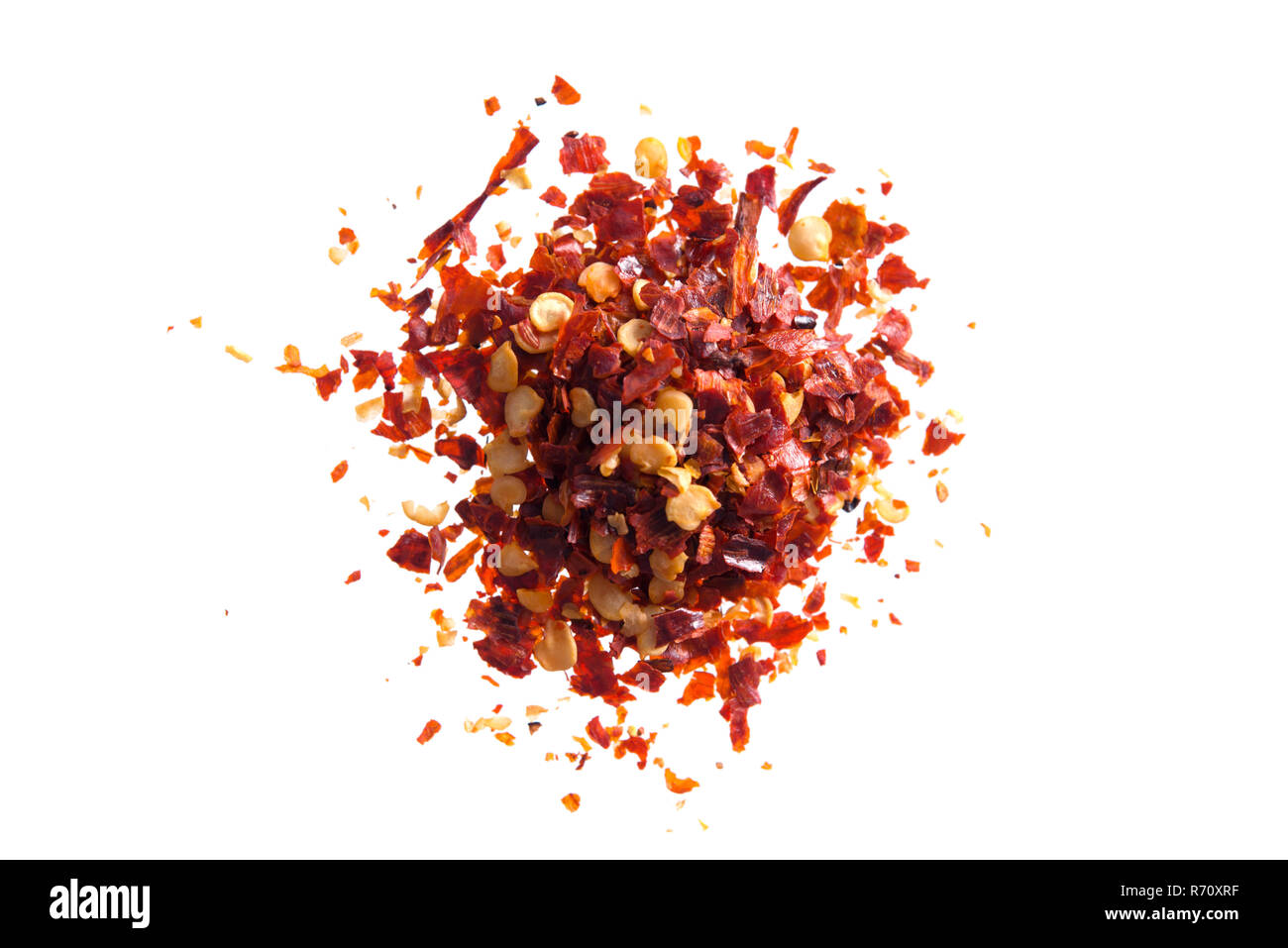 Pile crushed red cayenne pepper, dried chili flakes and seeds isolated on white background Stock