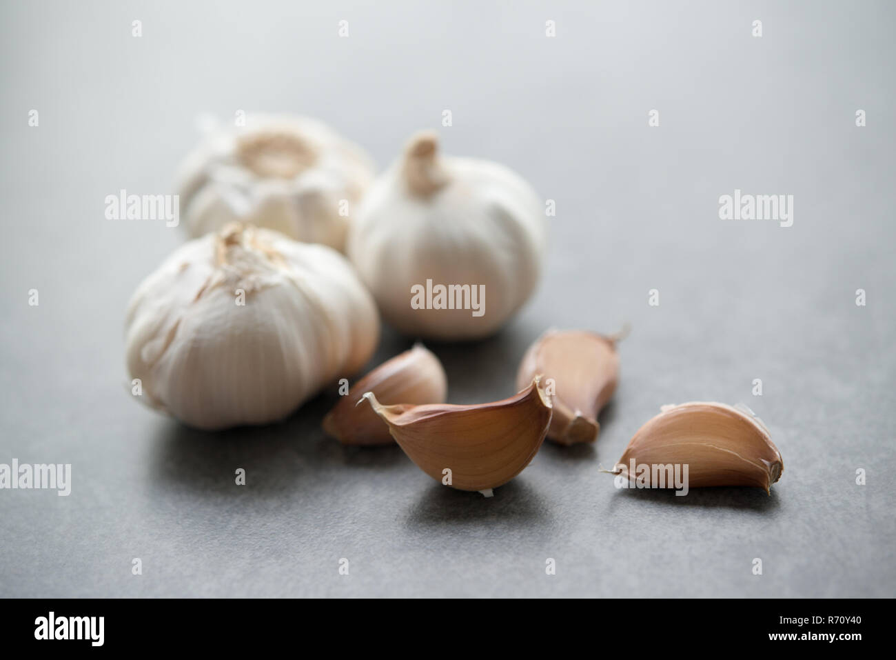 Garlic cloves and bulb with copy space on dark background Stock Photo ...