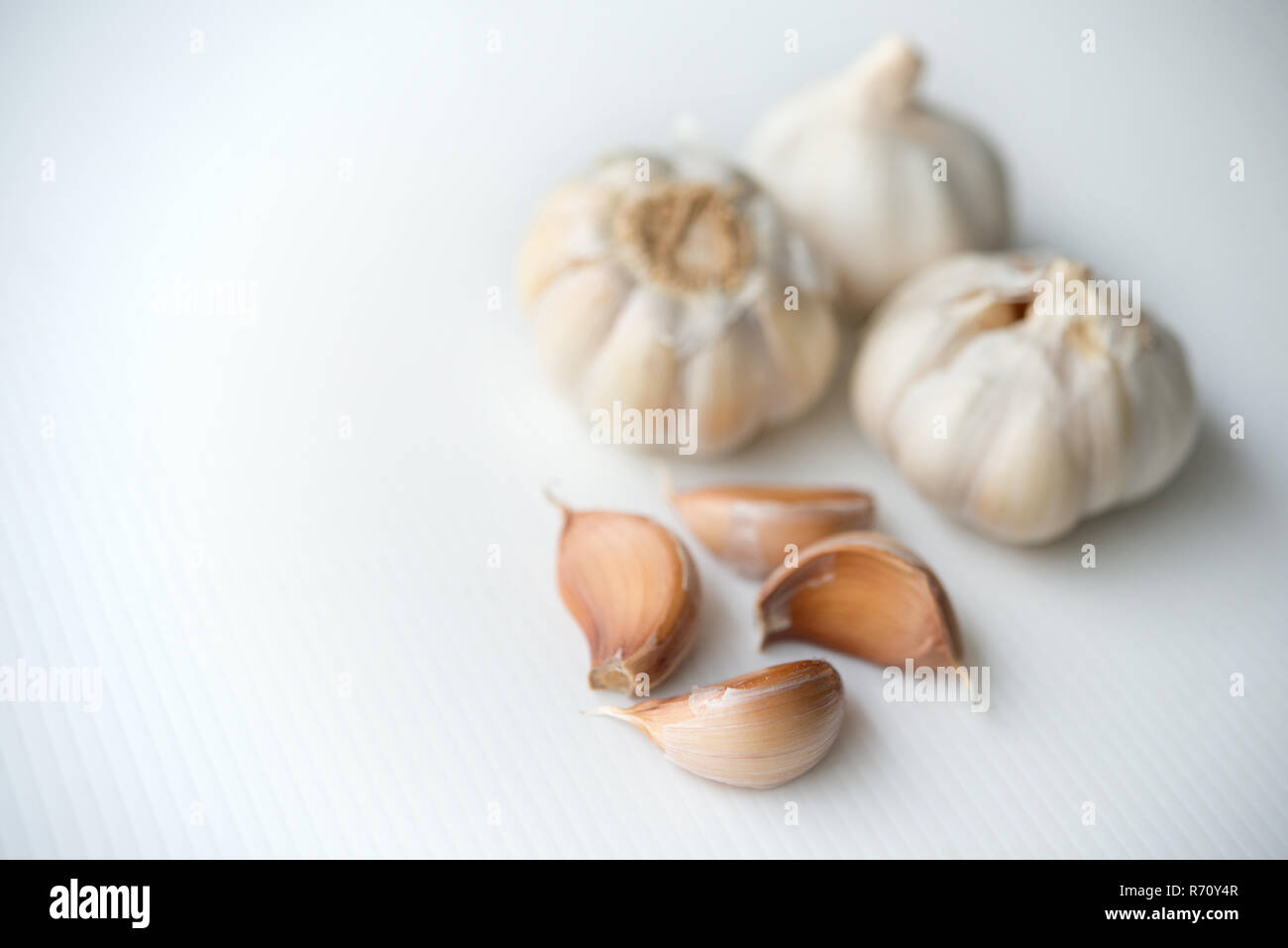 Garlic cloves and bulb with copy space on grey background Stock Photo ...