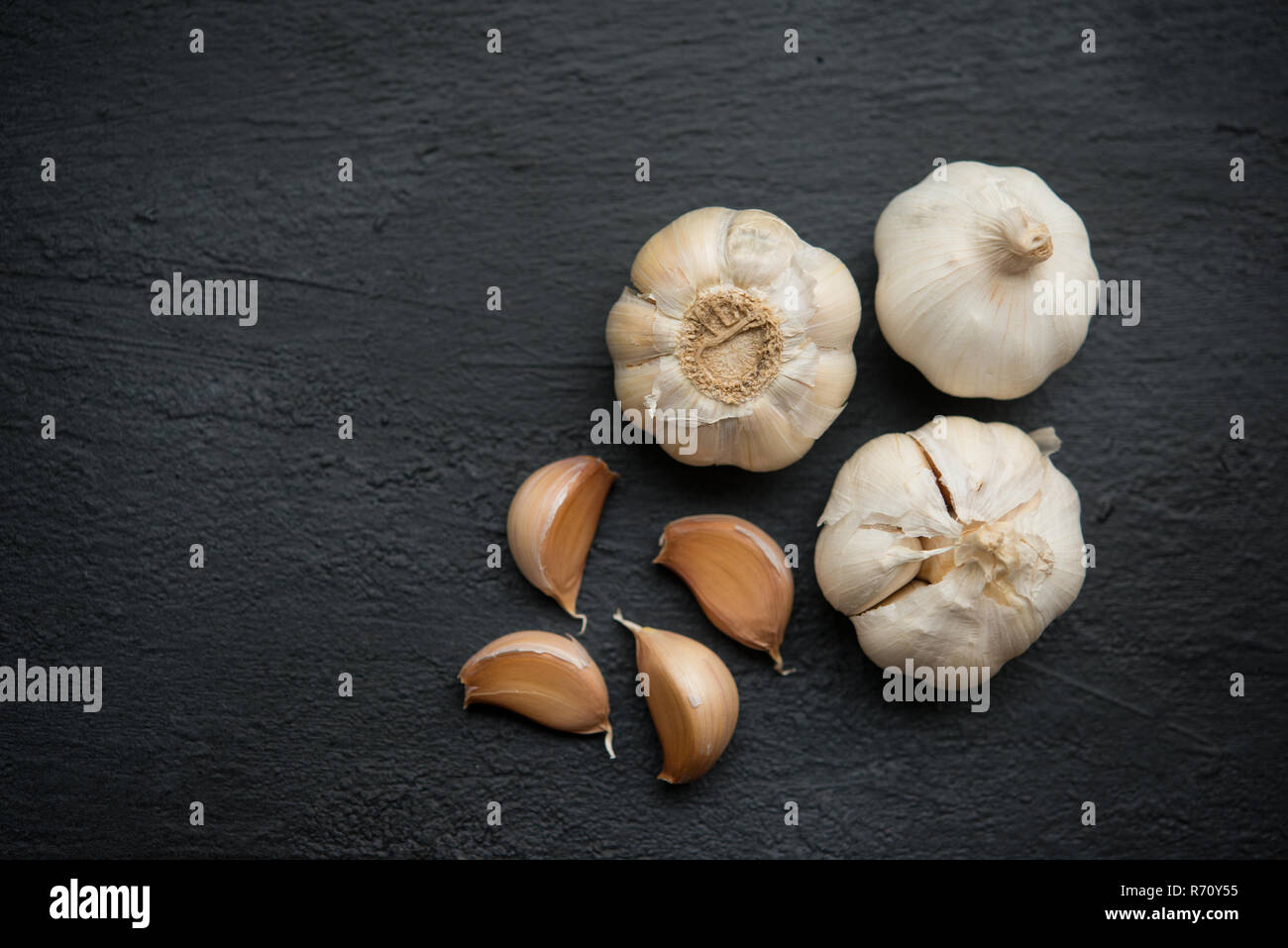 Top view garlic cloves and bulb with copy space on dark background ...