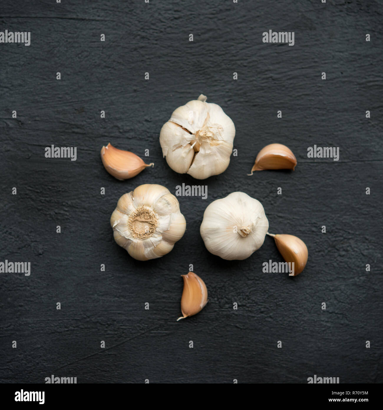 Top view garlic cloves and bulb on dark background Stock Photo - Alamy