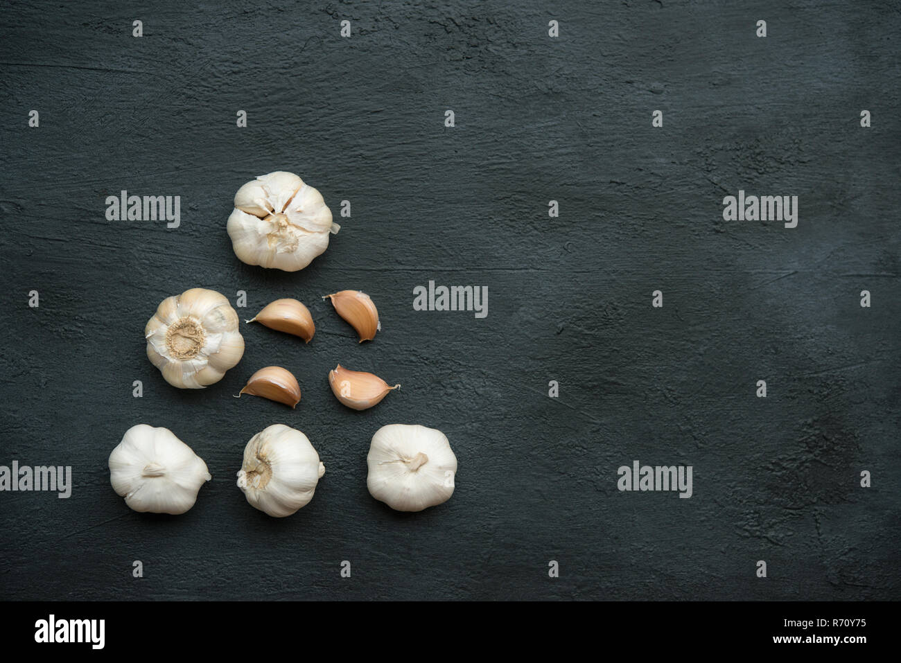 Top view garlic cloves and bulb with copy space on dark background ...