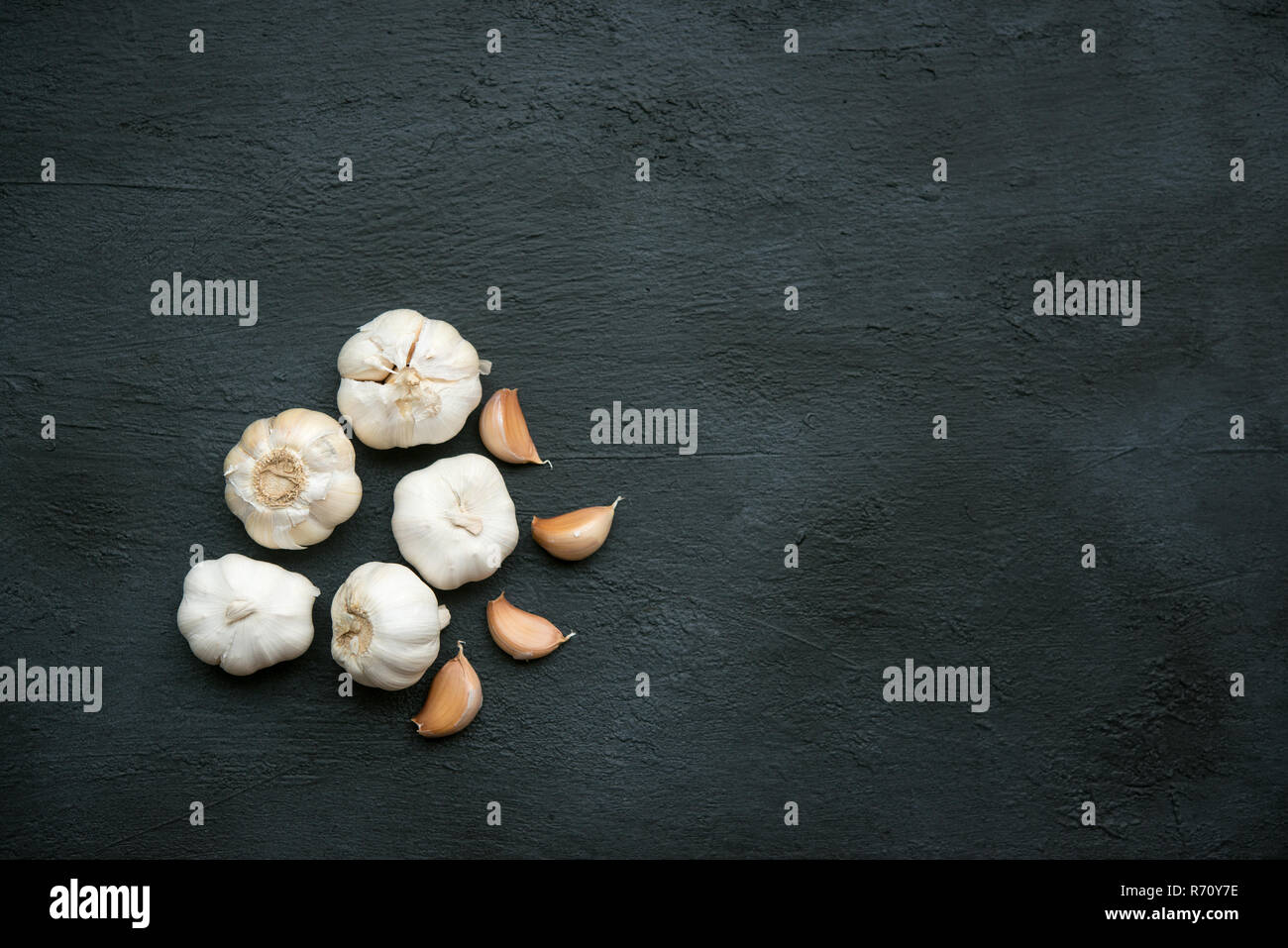 Top view garlic cloves and bulb with copy space on dark background ...