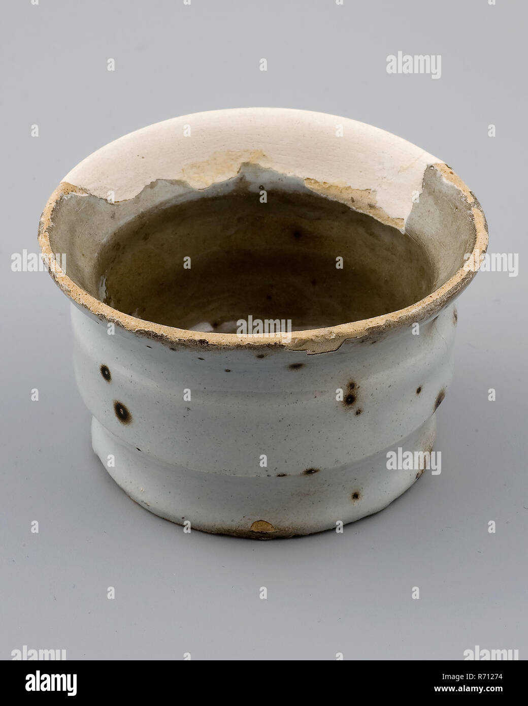 White pottery ointment jar with slightly profiled wall, with slightly protruding upper edge, ointment jar pot holder soil find ceramic earthenware glaze, edge hand turned baked glazed baked Pottery ointment jar with two notches White glazed. Funnel shaped top edge. Stand with soul and traces of traction Diameter of the foot is slightly smaller than the diameter of the sidewall. Discolored by staying in the soil Restoration is not repainted Delftware archeology Rotterdam Muted Slaak health care indigenous pottery ointment medicine drug care craft pharmacy Soil discovery Muted Slaak January 1978 Stock Photo