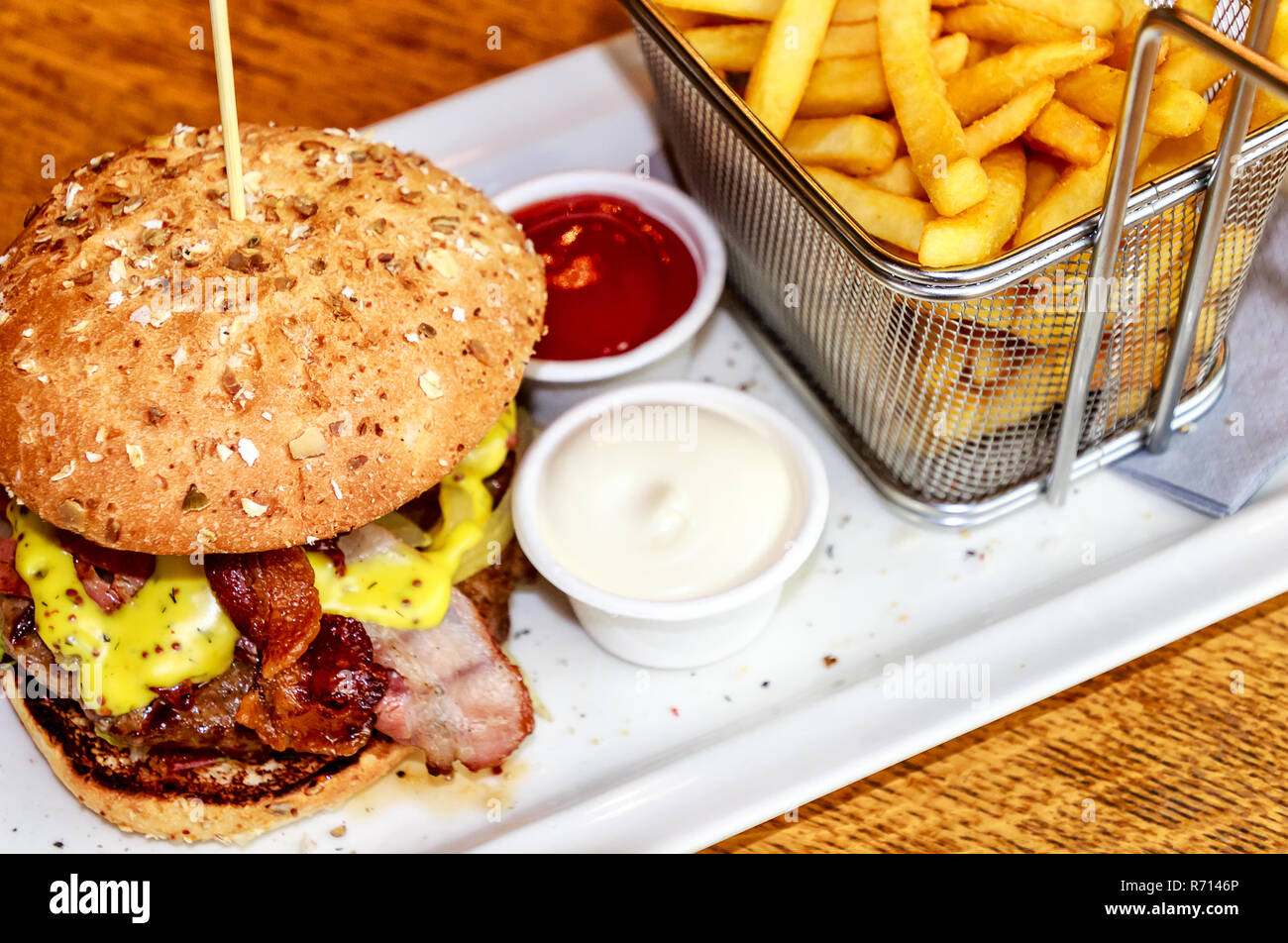 HoneyMustardBurger with French Fries in a small net basket Stock Photo Alamy