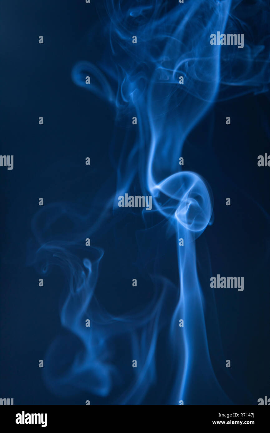 Abstract blue smoke swirls on dark background Stock Photo - Alamy