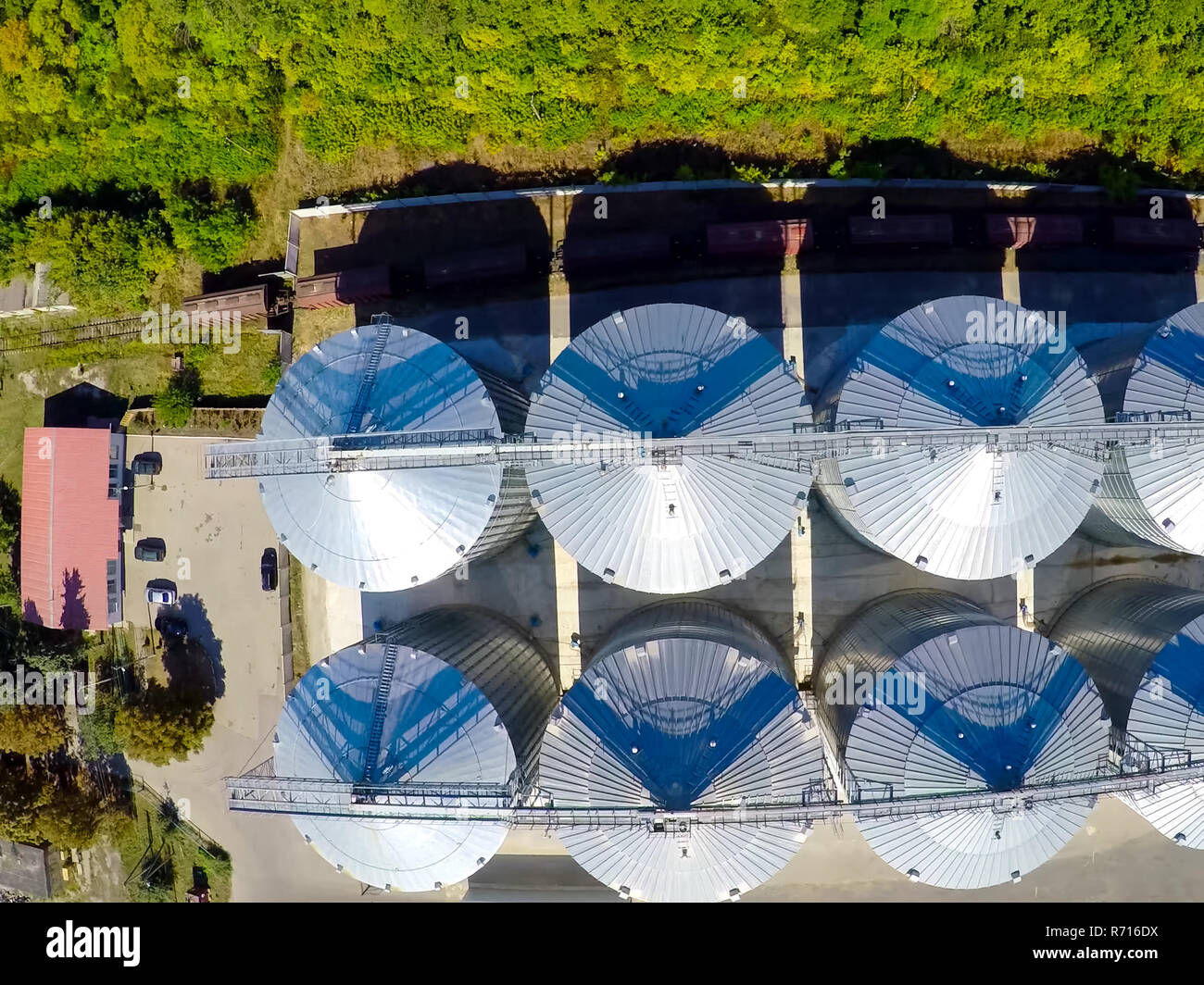 Flight of the grain terminal from the drone. The grain plant for storage and drying of grain. Grain terminal. Plant for the drying and storage Rice plant in the middle of fields Stock Photo