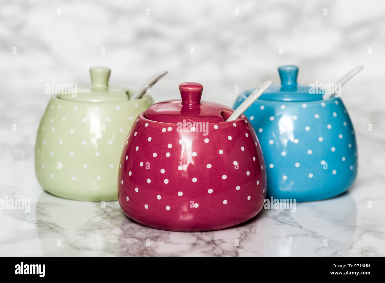 Cute Ceramic Storage Jars with Dots on White Stock Photo