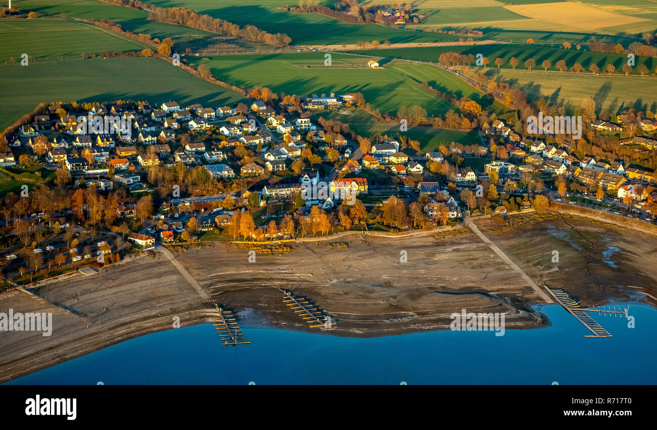 Aerial view, low water in the Möhnesee reservoir, wide shore area, moorings for boats are dry, Arnsberger Wald nature park Park Stock Photo