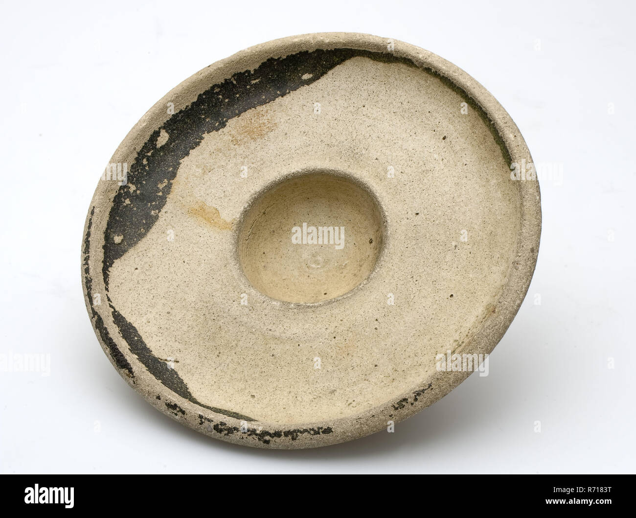 Very small Roman saucer, dish crockery holder soil find ceramic earthenware glaze, archeology Soil discovery of large rivers. Stock Photo