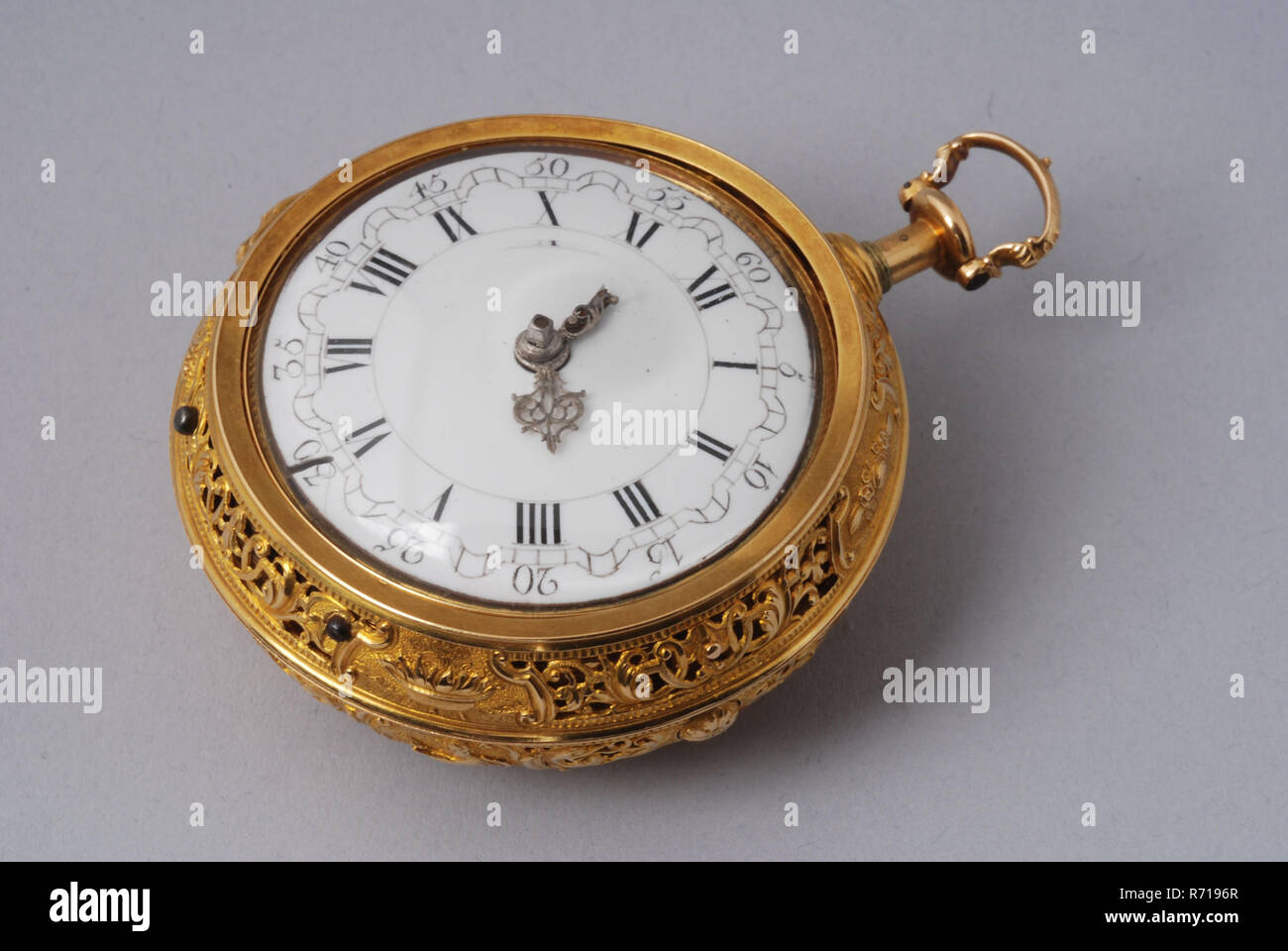 William Gib Junior, Pocket watch with golden ajour outside cabinet, ajour inner case with inset inside shell and dust case on movement, enamel dial, pocket watch watch movement measuring instrument gold enamel steel brass glass, box 6.0 White enamel dial with curved minute band with Arabic minute digits and Roman hour digits. Ajourge sawed steel hands The clock with spindle and repetition mechanism for hours and quarters. Simple round pillars. The back plate with an ajour sawed bridge in asymmetrical ornamentation and ditto ornament screwed with blued screws Silver plated 'compass' with the nu Stock Photo