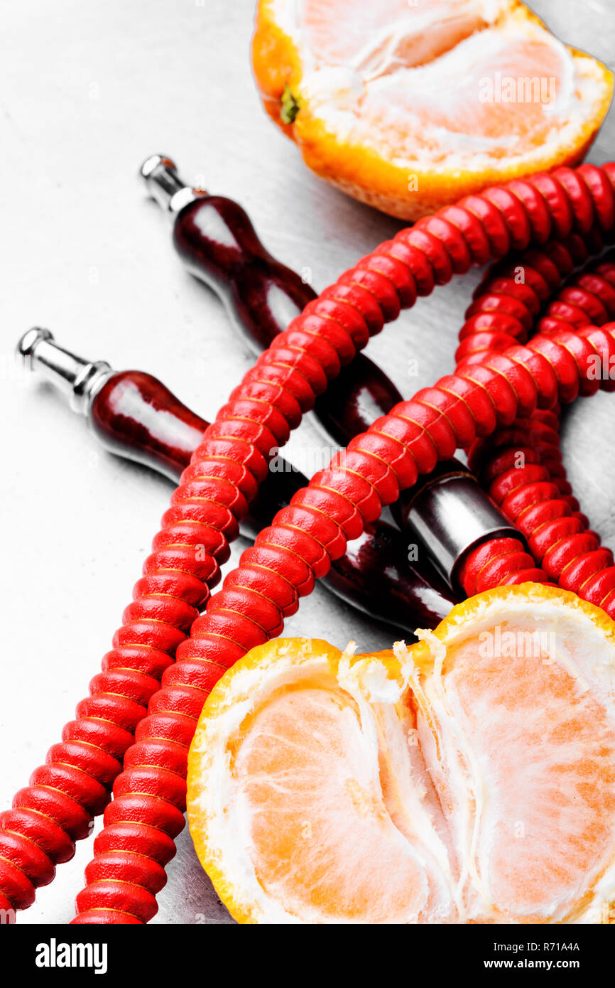 Eastern smoking hookah with mouthpieces with tangerine flavor.Shisha
