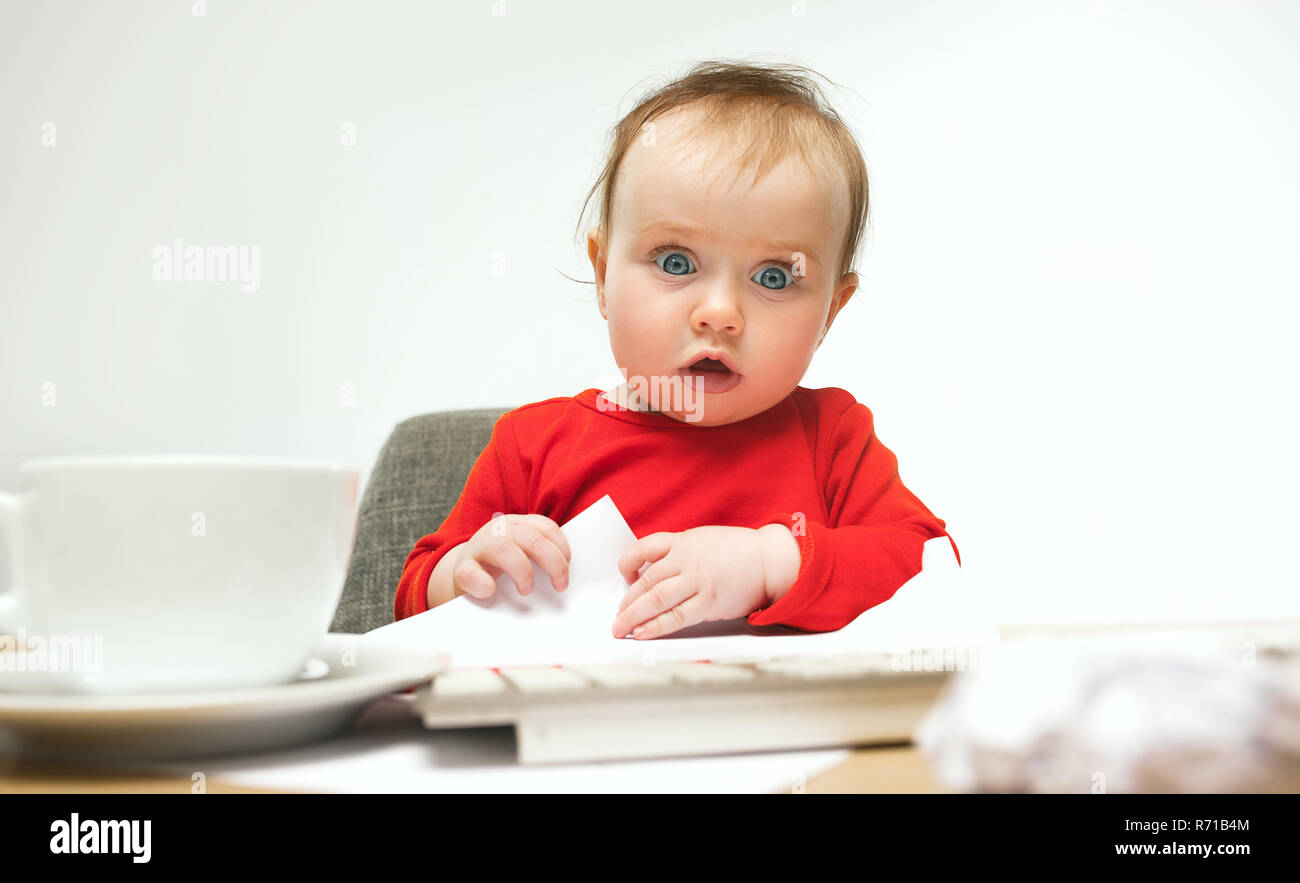 Happy child baby girl toddler sitting with keyboard of computer ...
