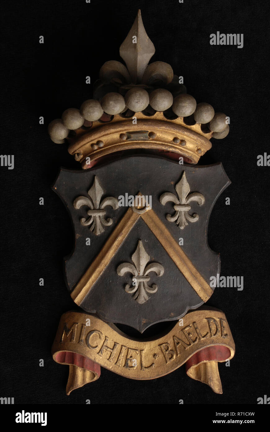 Carved wooden crowned coat of arms including the name Michiel Baelde