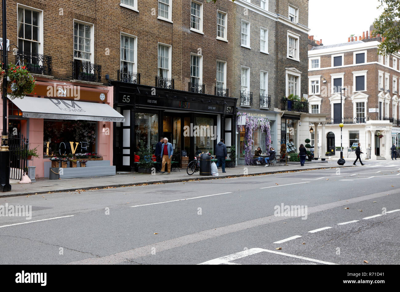 PM Flowers, Absiso food store and Saint Aymes  chococatier and coffee shop on Connaught Street, Connaught Village, London, UK Stock Photo