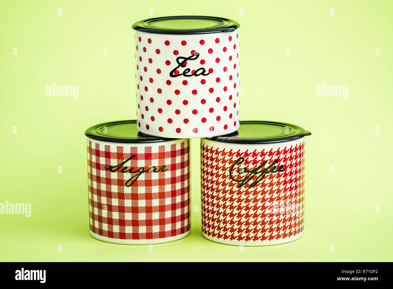 Red, White Ceramic Storage Jars on Green Background Stock Photo