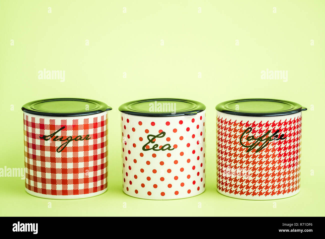 Red, White Ceramic Storage Jars on Green Background Stock Photo