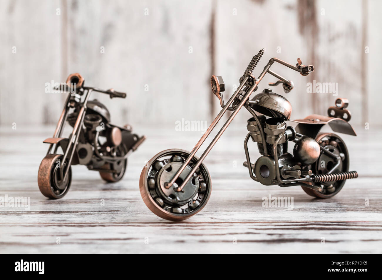 Mini Metal Model Motorcycle on White Wooden Background Stock Photo
