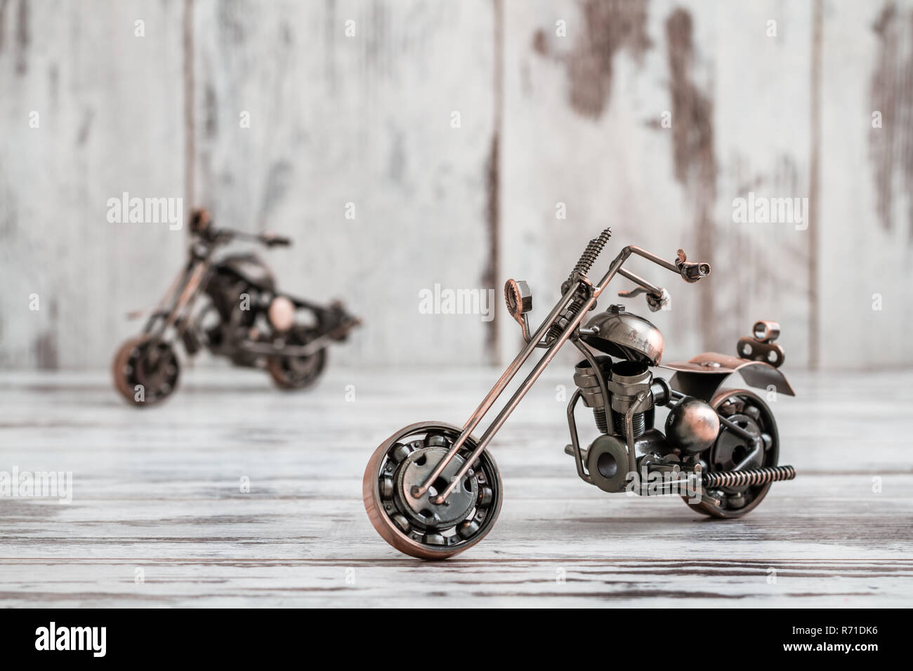 Mini Metal Model Motorcycle on White Wooden Background Stock Photo