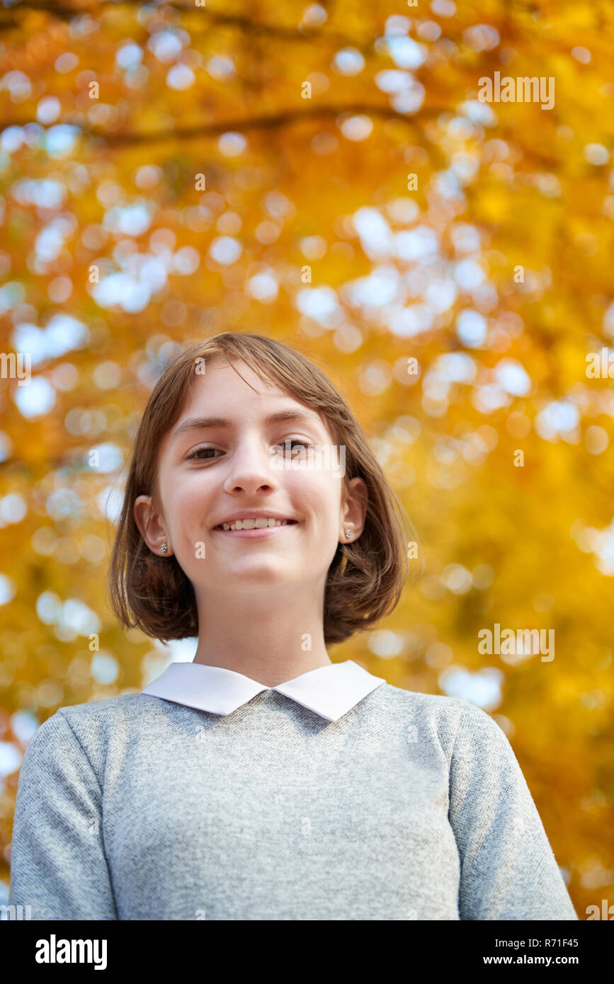 School-age cute girl posing in the Park for a photoshoot Stock Photo - Alamy