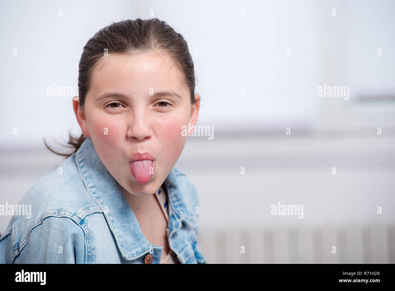 pretty girl pulling out the tongue Stock Photo Alamy