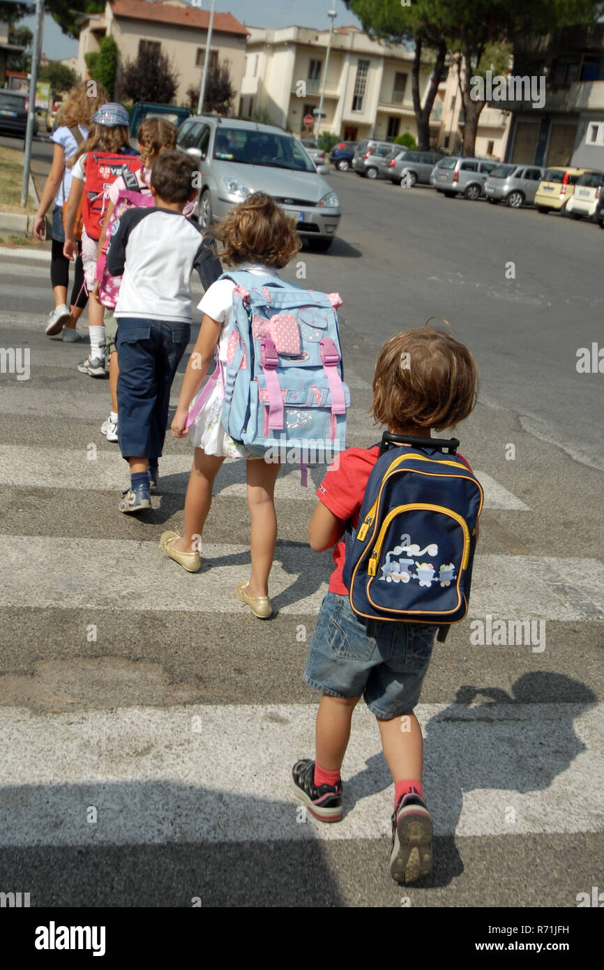 Schoolchilds  in a row walking on the pedestrian crossing    Photo © Daiano Cristini/Sintesi/Alamy Stock Photo Stock Photo
