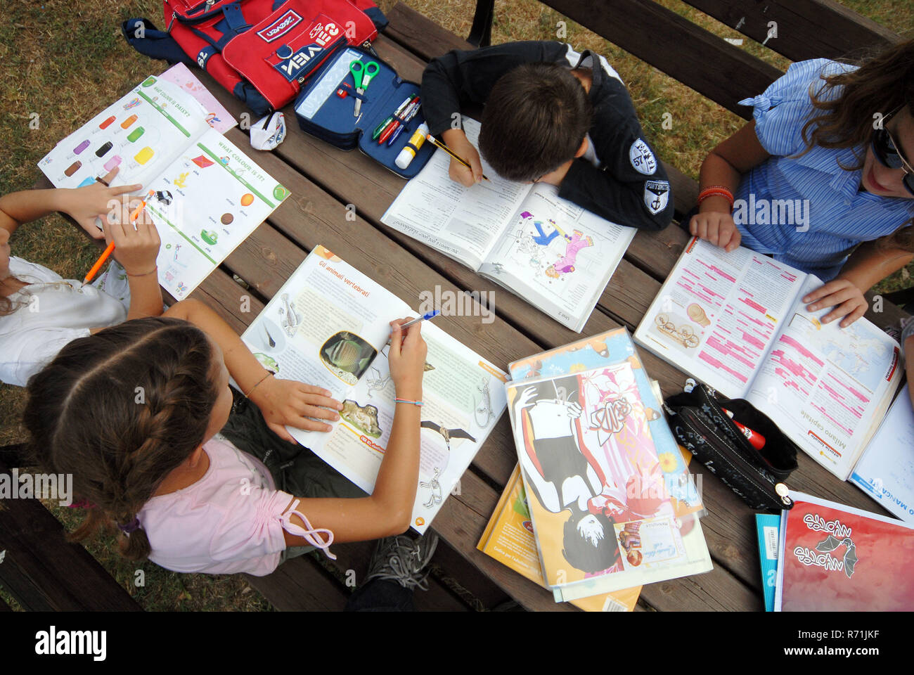 Group of childrens doing holidays homework in the garden    Photo © Daiano Cristini/Sintesi/Alamy Stock Photo Stock Photo