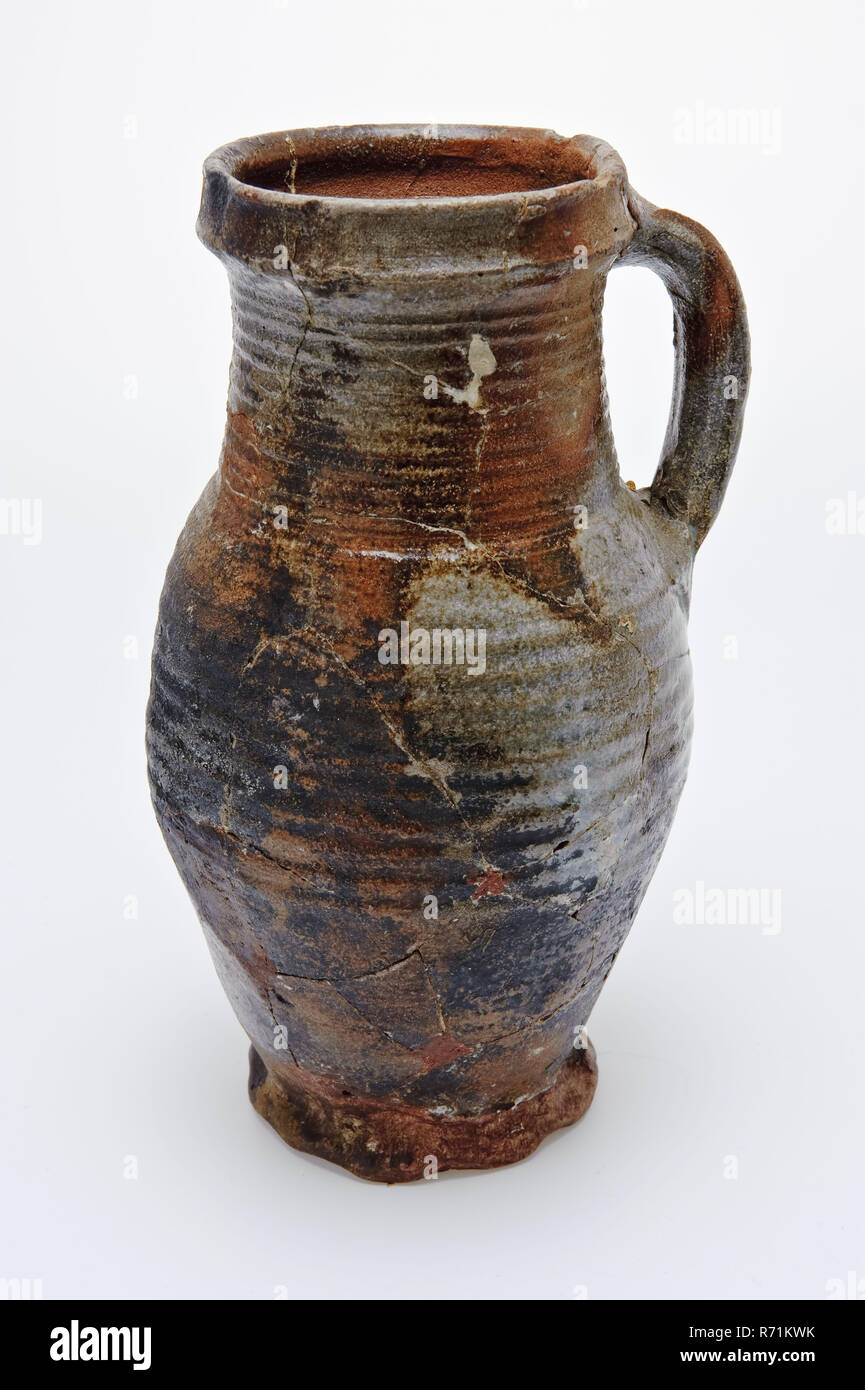 https://c8.alamy.com/comp/R71KWK/stoneware-pot-on-pinched-foot-mottled-brown-glaze-drinking-jug-cup-drinking-utensils-tableware-holder-soil-find-ceramic-stoneware-clay-engobe-glaze-salt-glaze-hand-turned-glazed-baked-stoneware-pot-jug-on-pinched-foot-braided-sidewall-and-cylindrical-neck-swivel-spindles-over-the-entire-height-mottled-brown-glaze-archeology-poortugaal-albrandswaard-indigenous-pottery-import-serving-serve-drinking-wine-beer-soil-discovery-poortugaal-R71KWK.jpg