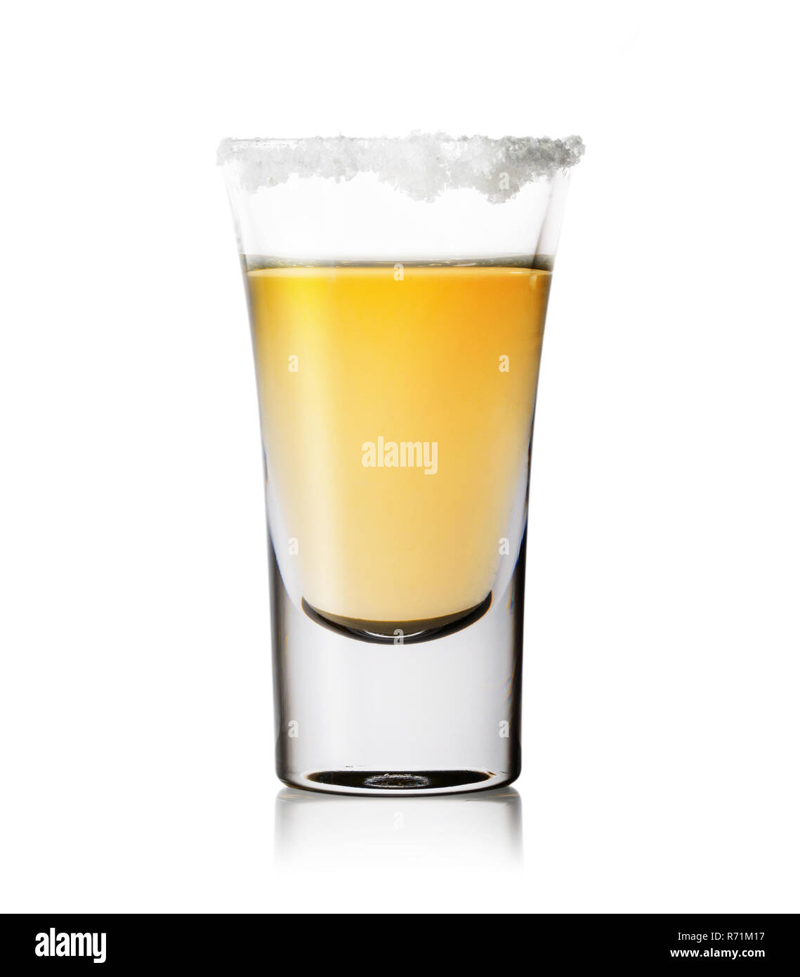 Glass of tequila with salt on the rim isolated on white background. Gold tequila. Traditional