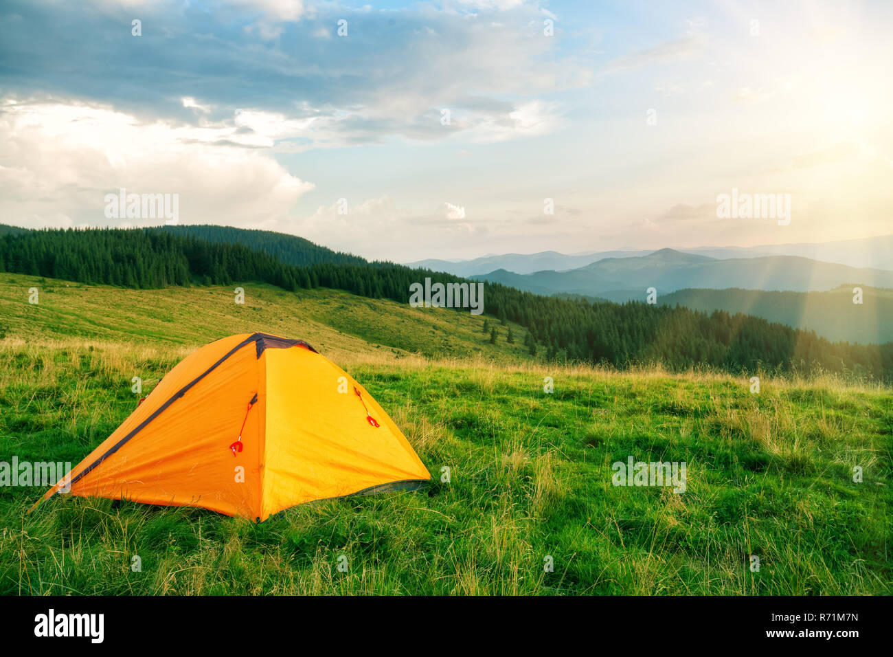 Orange tourist tent in the mountains under the bright sun Stock Photo ...