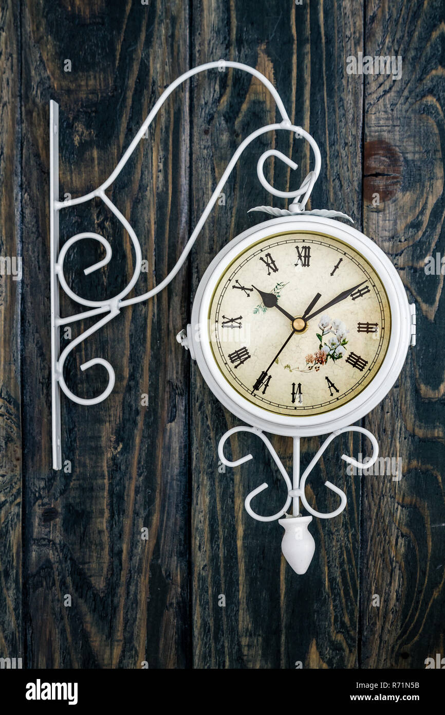Wall Clock with Decorative Wrought Iron Butterfly Hanger on Blue Stock