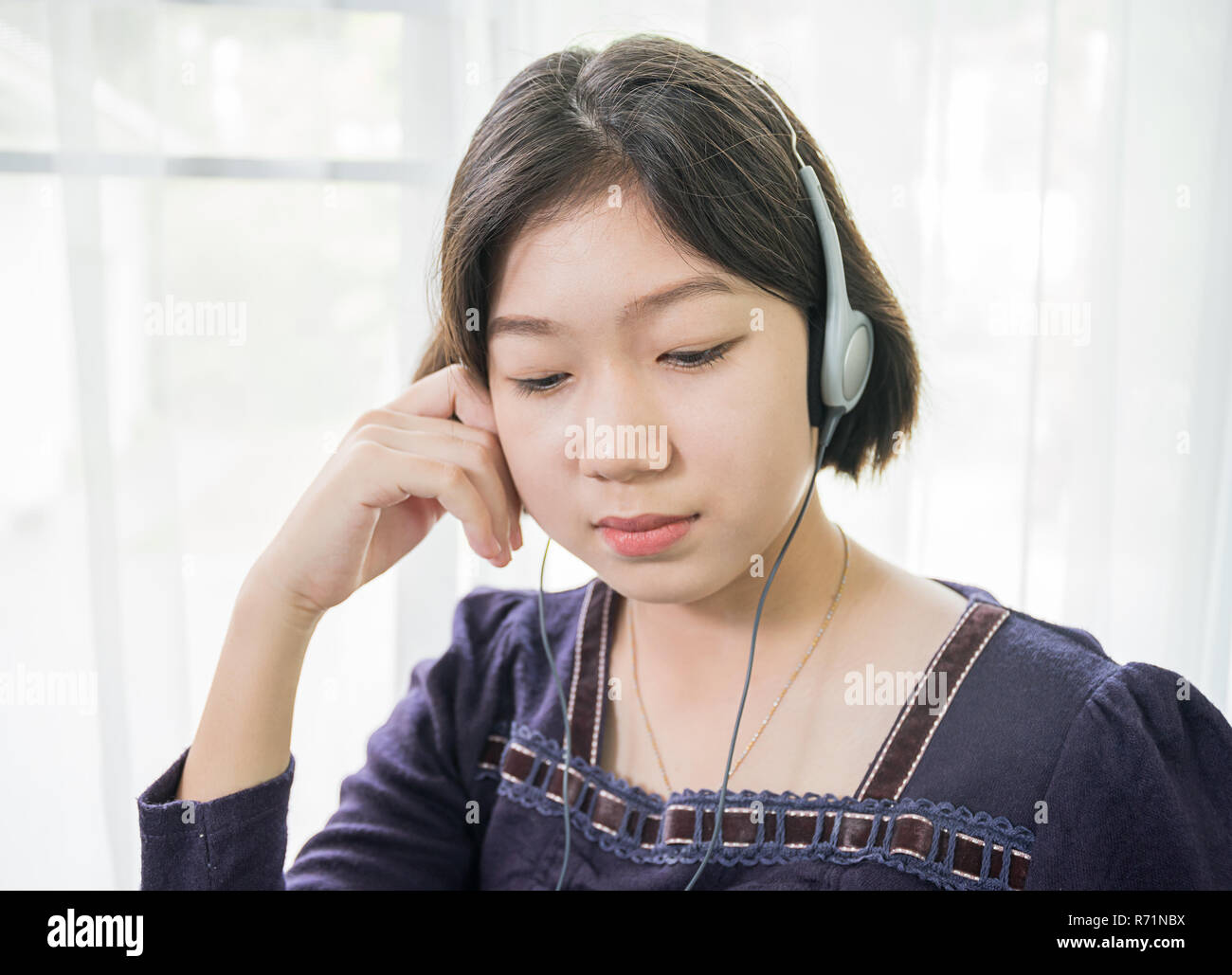 Young Asian Woman Short Hair Listening Music In Living Room Stock