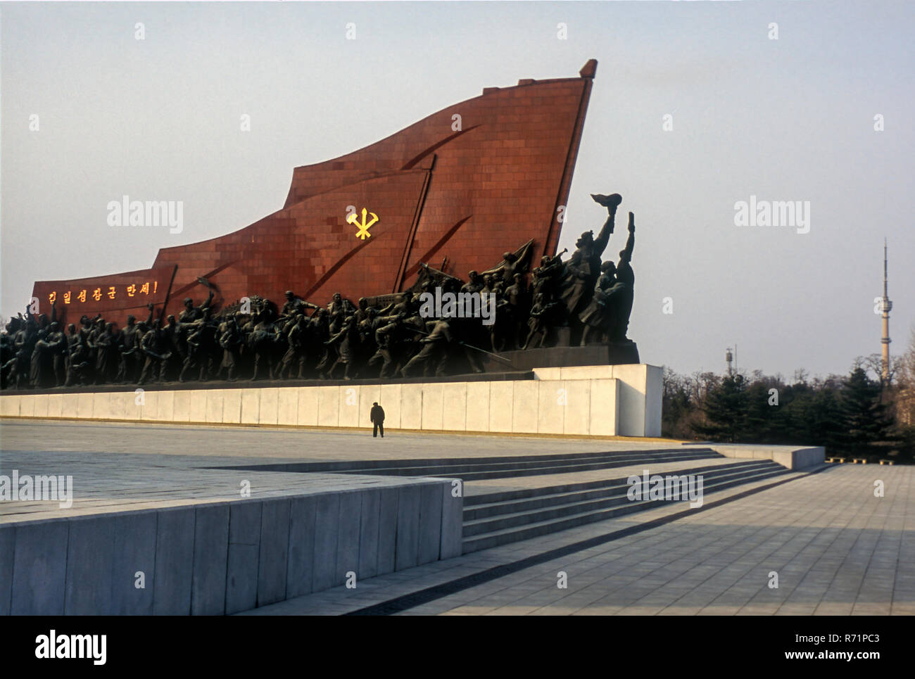 A giant bronze statue of Kim Il Sung dominates a Pyongyang hilltop, surrounded by socialist realistic sculptures. Stock Photo