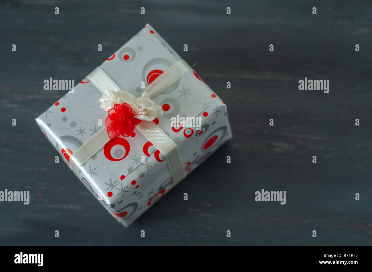 Gift box with red and white ribbon bow on the black background Stock ...