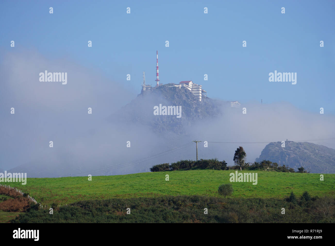 Fog lifting on the high peak of Ibardin, Spain on a clear summer day Stock Photo