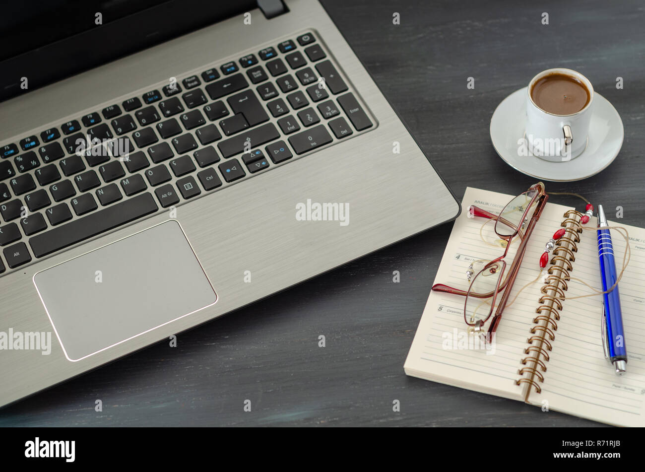 Office desk with laptop computer, notebook, pen and coffee cup Stock