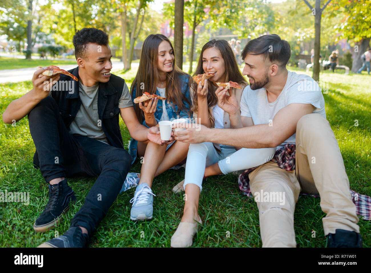 Group of friends having picnic in park hi-res stock photography and ...